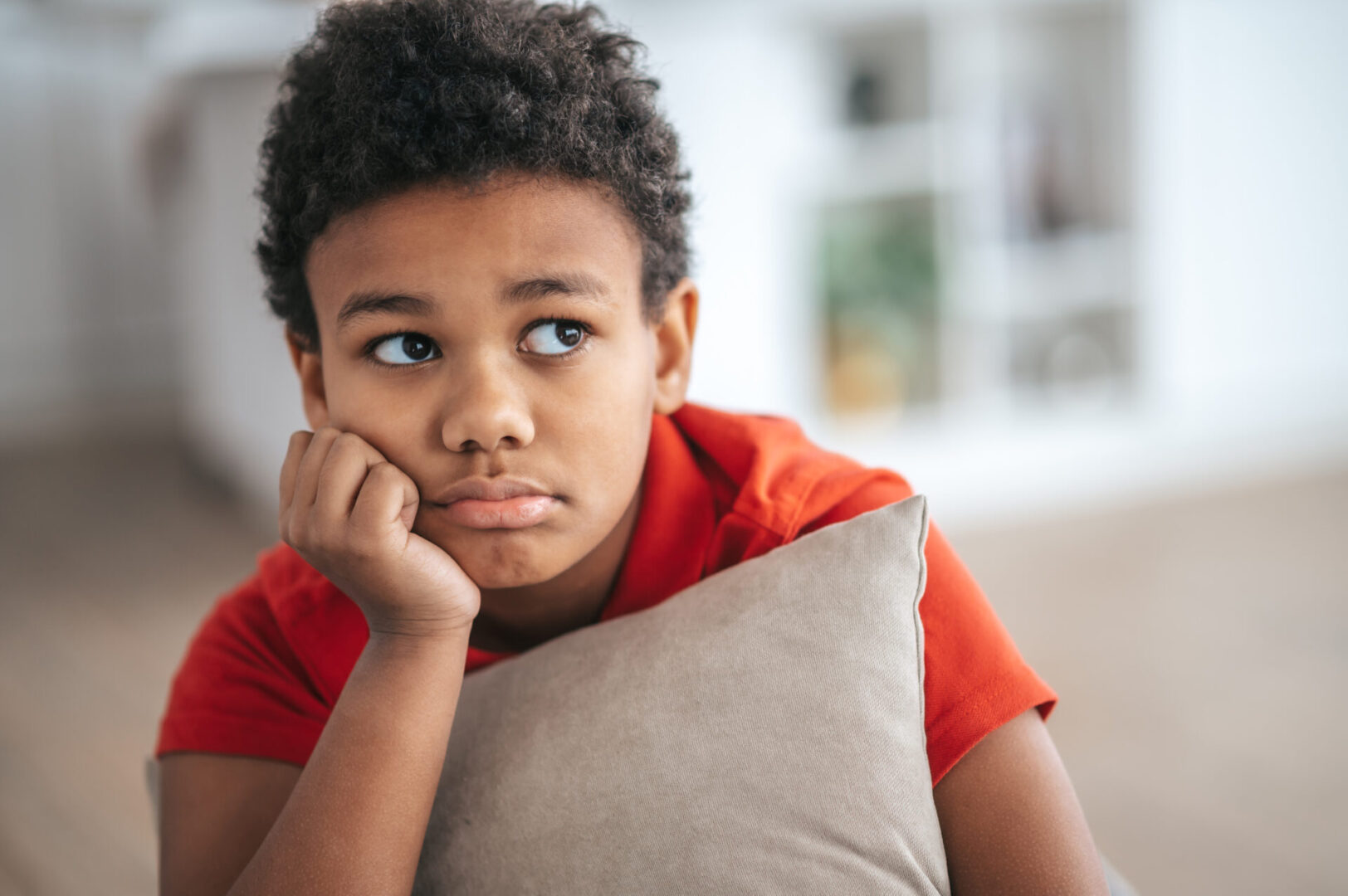 A boy with a pillow in hands looking upset Calm Kids: Anxiety Skills Center