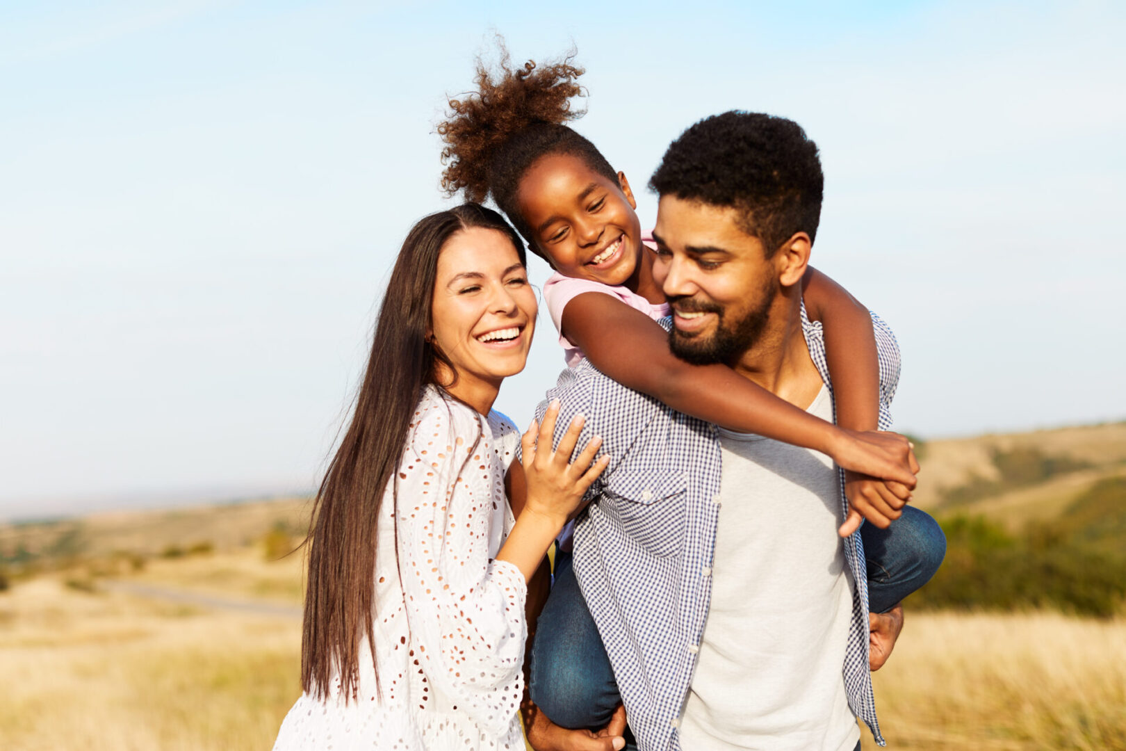 child daughter family happy mother father piggyback fun together girl cheerful field outdoor natur summer Calm Kids: Anxiety Skills Center