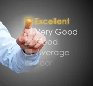 A person is touching an excellent word on the screen.