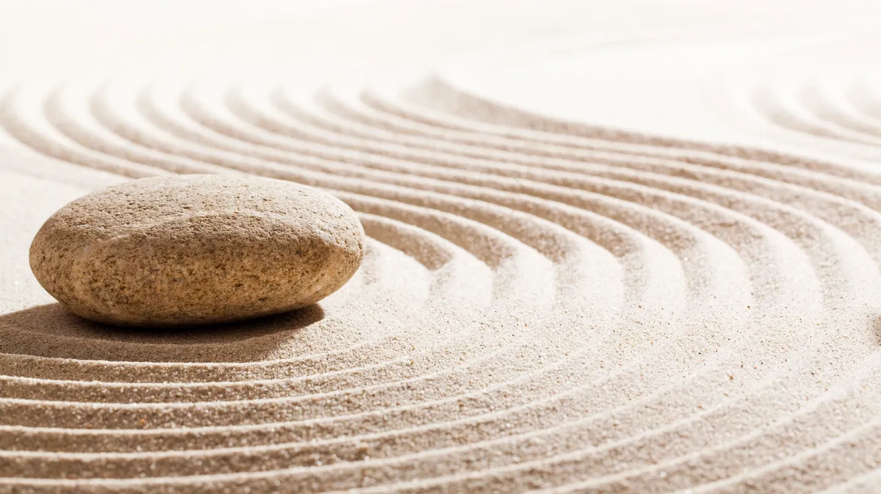 rs=w_1280 (10) A rock sitting on top of sand in the middle of a circle.