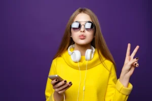 A woman wearing sunglasses and holding a cell phone.