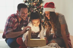 A family opening up a christmas present.