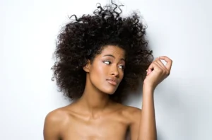 A woman with very long hair is posing for the camera.